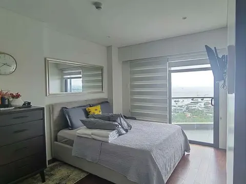 A large bedroom with a sea view